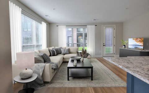 A modern living room with a grey sofa and a coffee table.