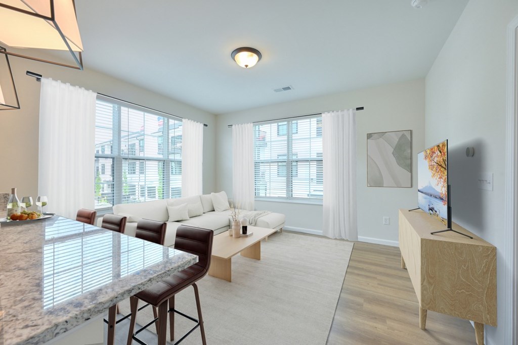 A modern living room with a marble countertop and white furniture.