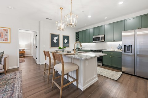 A kitchen with a table and chairs in the middle of it.