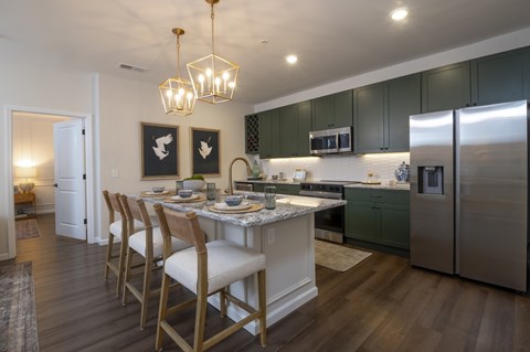 A kitchen with a table and chairs.