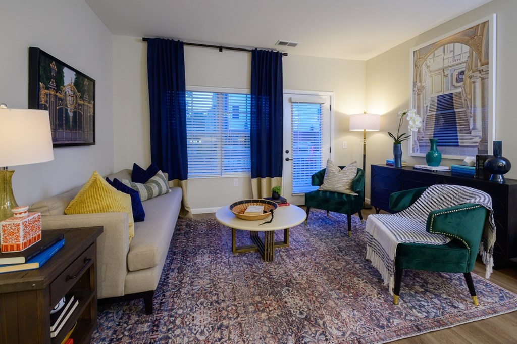 A living room with a couch, chair, and table.