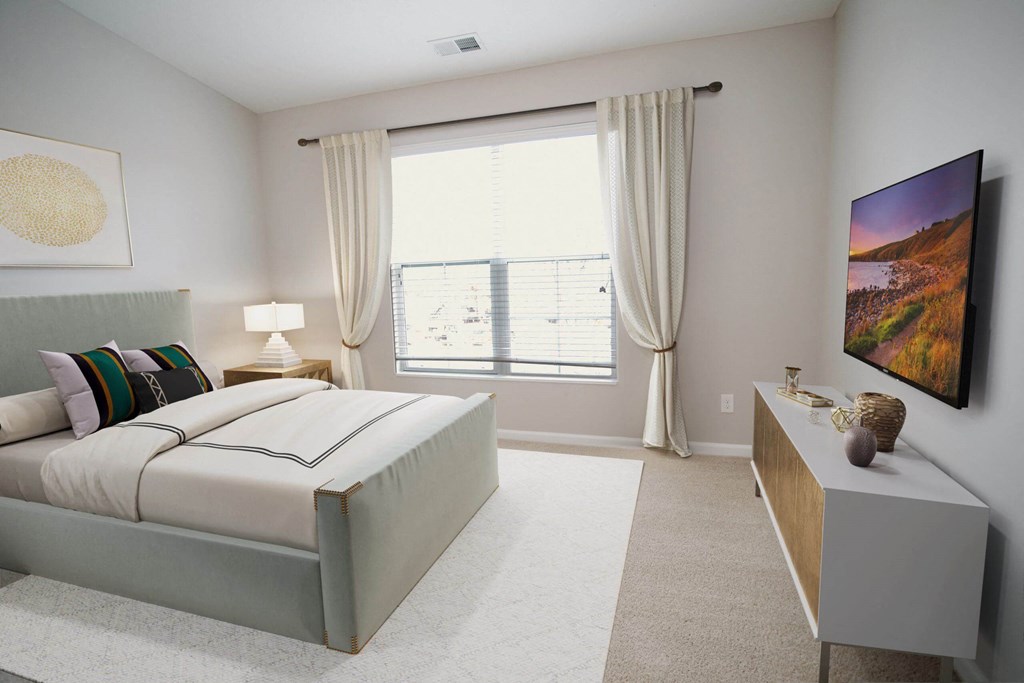 a bedroom with a large bed and a large window at Kendall Park, Columbus, OH