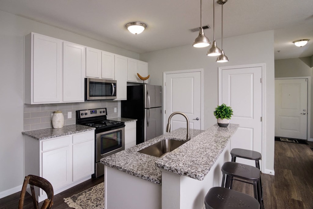 a kitchen with white cabinets and a granite counter top at Kendall Park, Columbus, Ohio