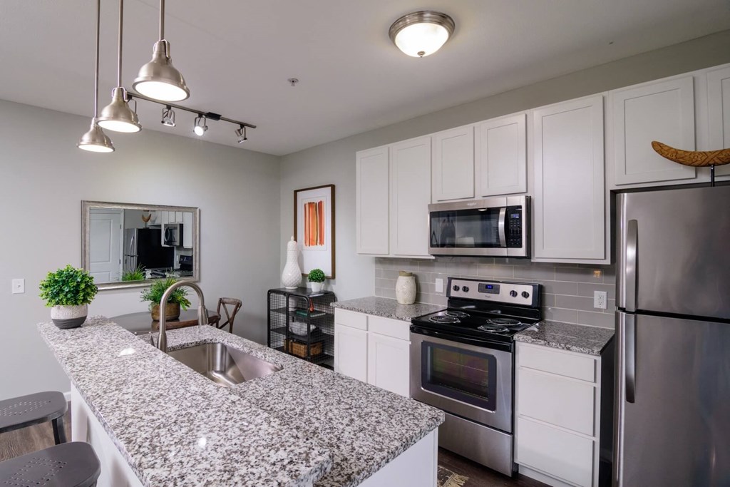 an open kitchen with granite countertops and stainless steel appliances at Kendall Park, Columbus, 43220