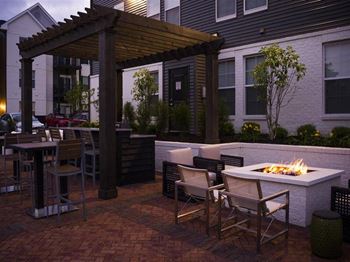 a patio with a fire pit and tables and chairs at Kendall Park, Columbus