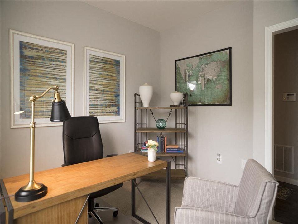 a desk with a chair and a lamp in a room at Kendall Park, Ohio