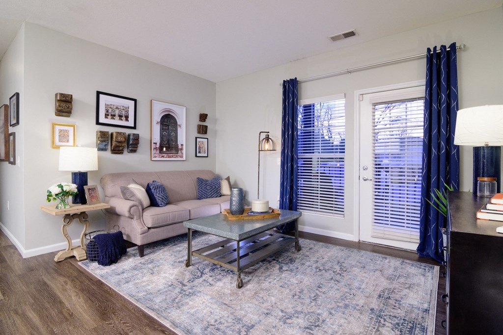 a living room with a couch coffee table and french doors at Kendall Park, Columbus, Ohio