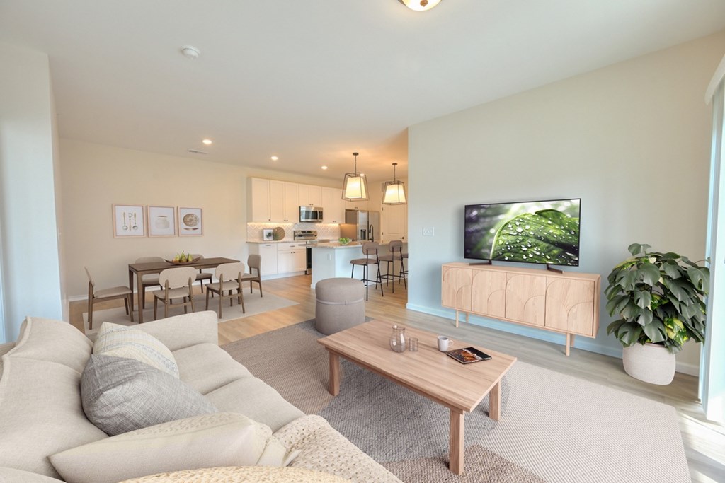 A living room with a grey couch and a wooden coffee table.