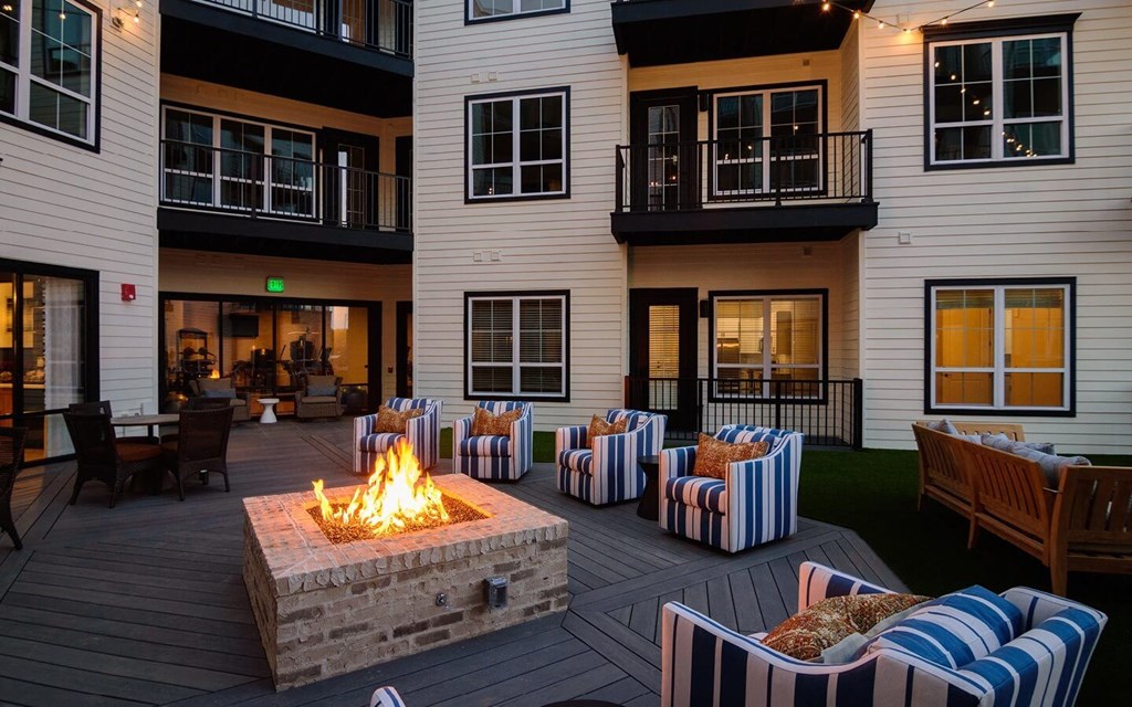 an outdoor patio with a fire pit and chairs  at Essex, Columbus, 43212