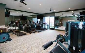 a room filled with lots of different types of exercise equipment at Fairfax, Grandview, 43212
