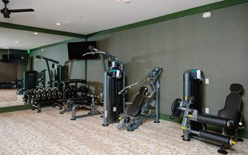 a room filled with lots of different types of exercise equipment at Fairfax, Grandview, OH