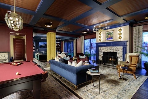 a living room with a pool table and a fireplace