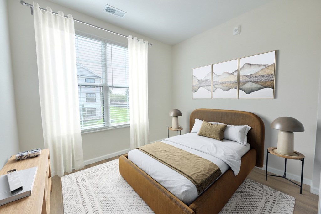 A bedroom with a large bed and a painting on the wall.