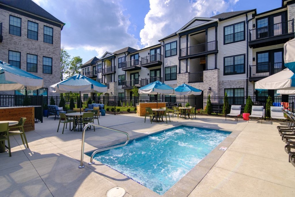 our apartments offer a pool and patio area with umbrellas at Dalton, New Albany Ohio