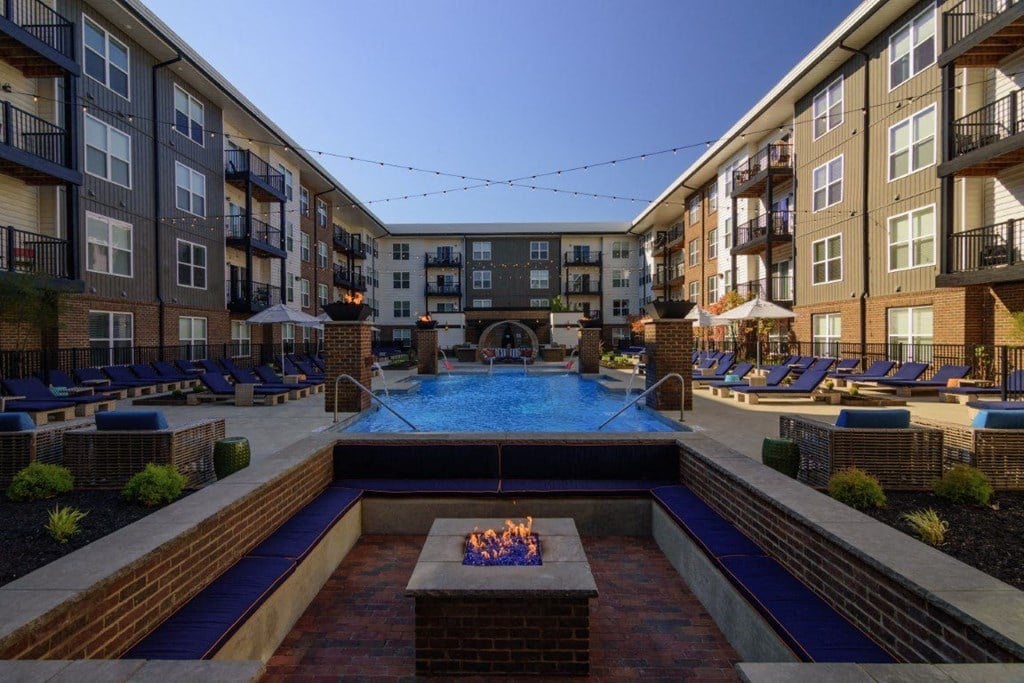 an outdoor pool with a fire pit in front of an apartment buildingat Taylor House Apartments, Columbus, OH, 43214