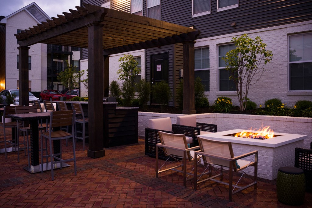 a patio with tables and chairs and a fire pit at Kendall Park, Columbus