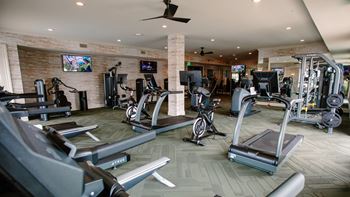 a gym with treadmills and other exercise equipment at Kendall Park Too, Columbus