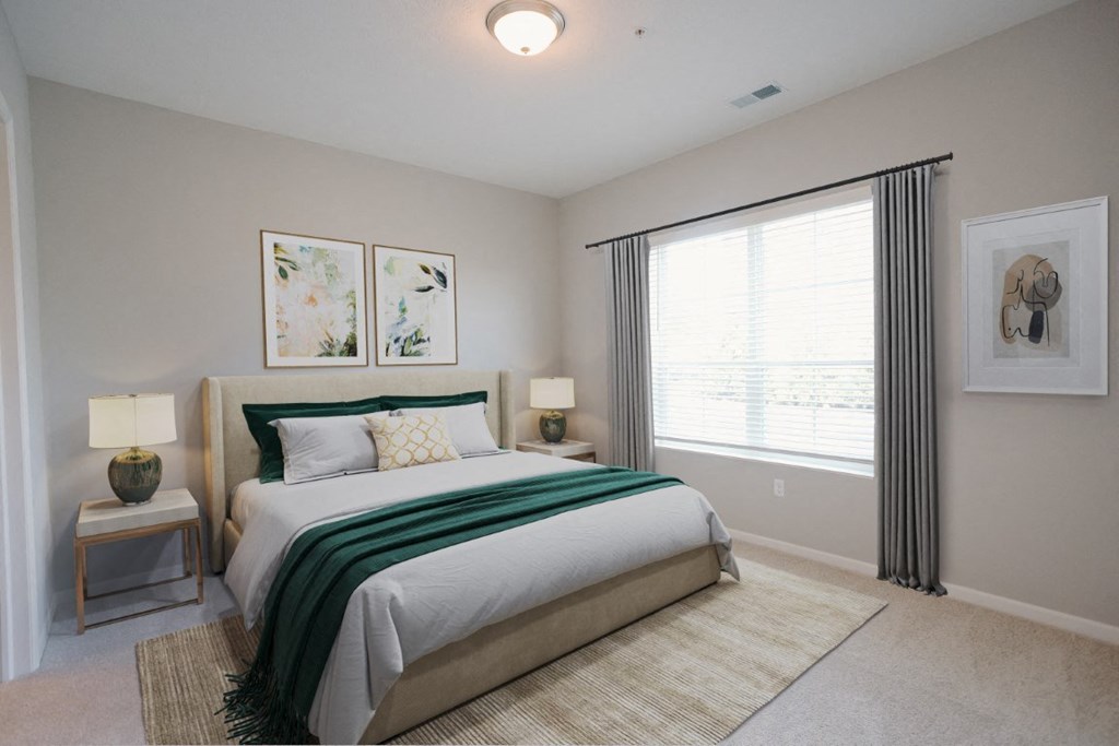 a bedroom with a large window and a bed with a green blanket at Kendall Park Too, Ohio