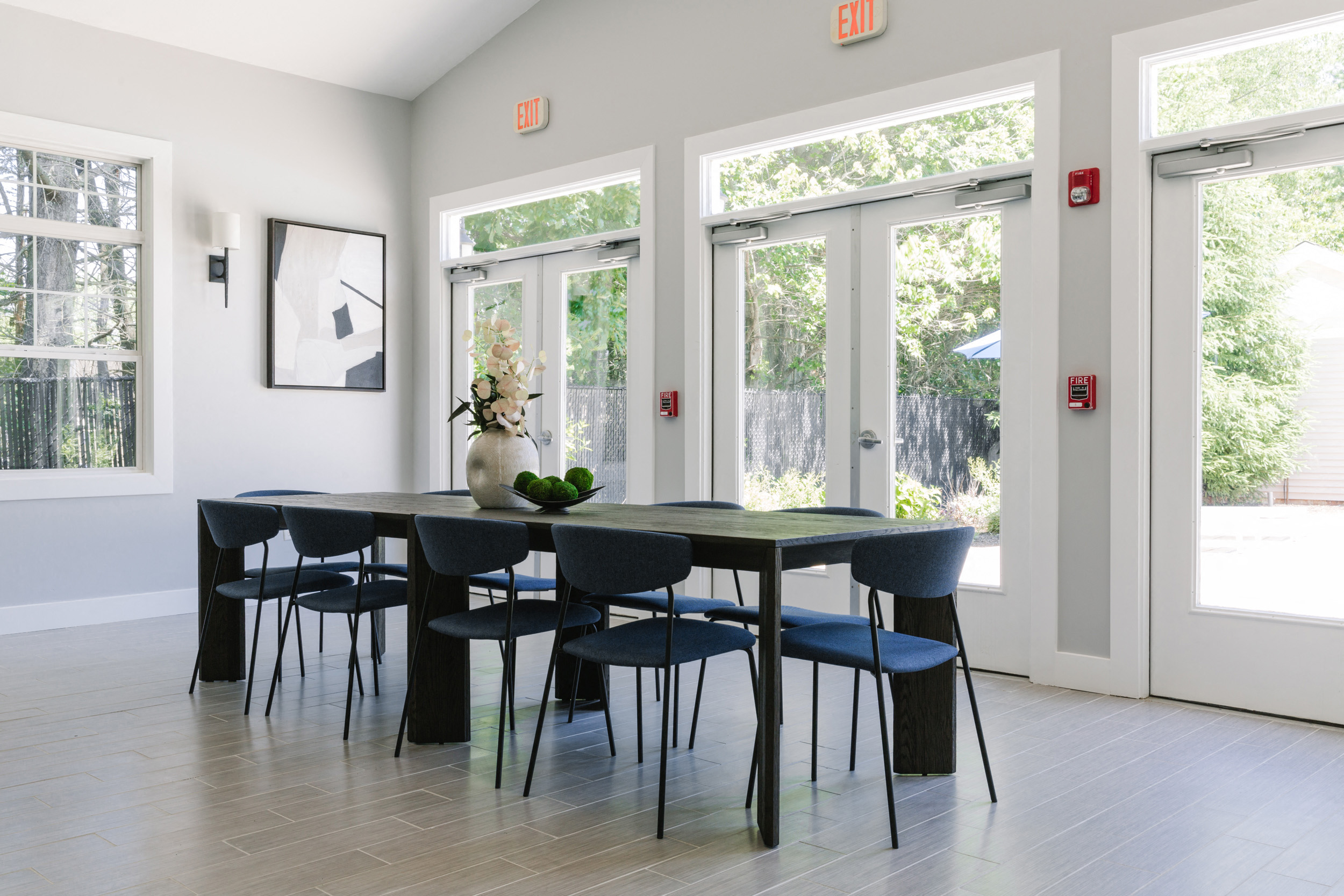 A dining room with a table and chairs.