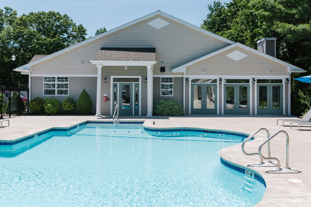 A pool in front of a house.