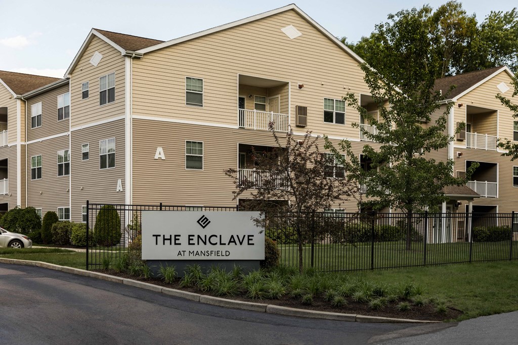 The Enclave at Mansfield is a large apartment complex with multiple buildings and balconies.