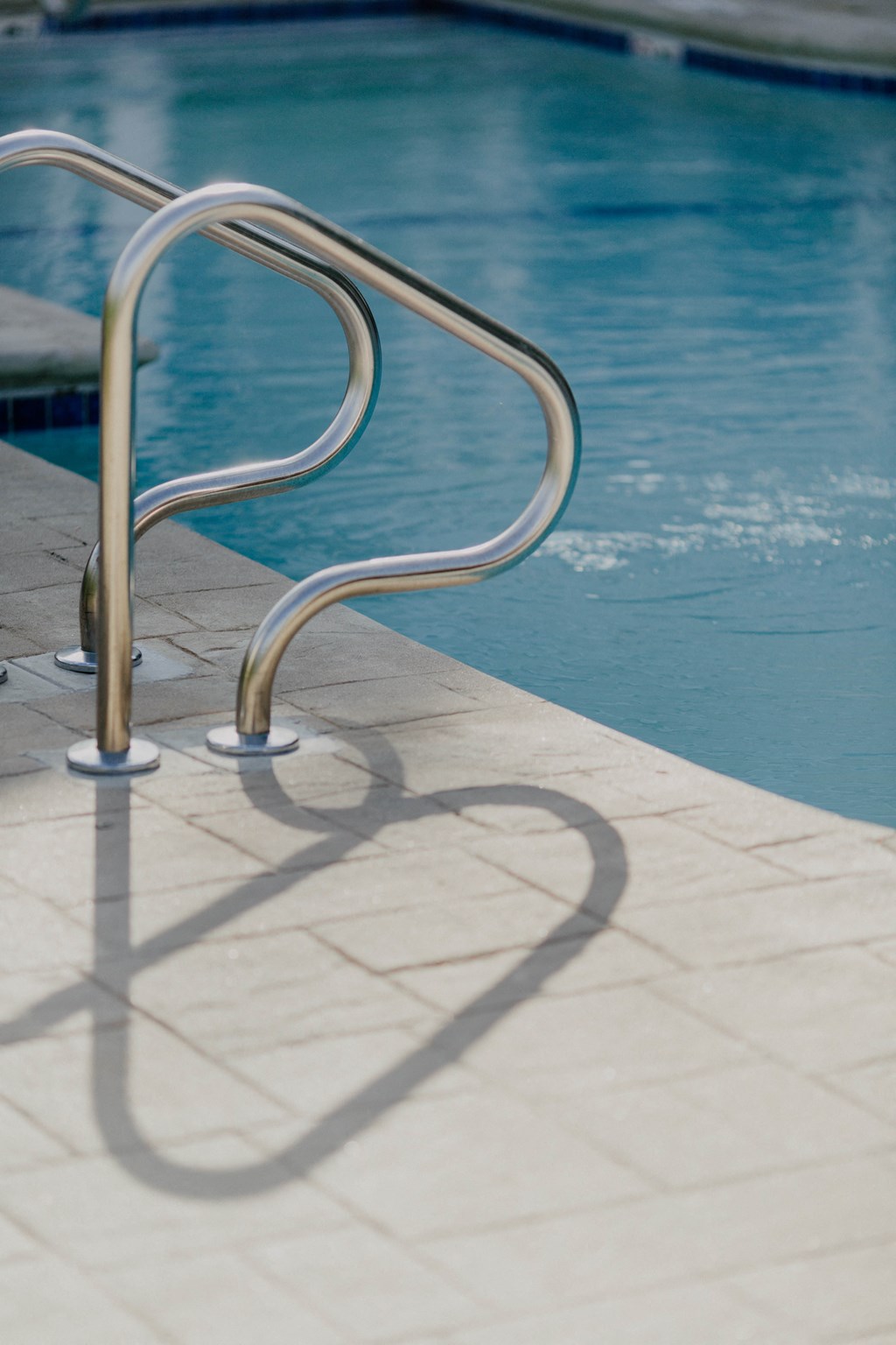 A pool ladder is in the water.