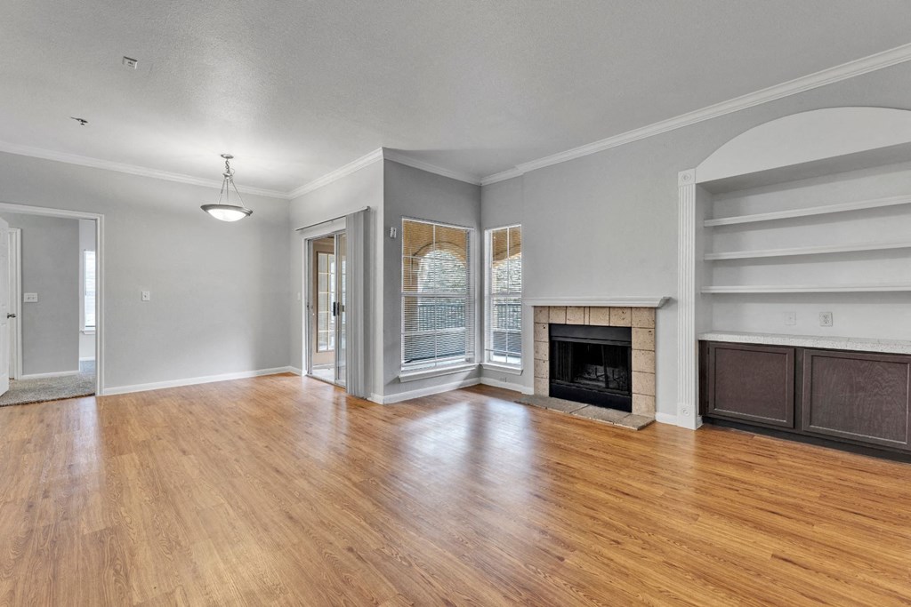 A living room with a fireplace and a sliding door.