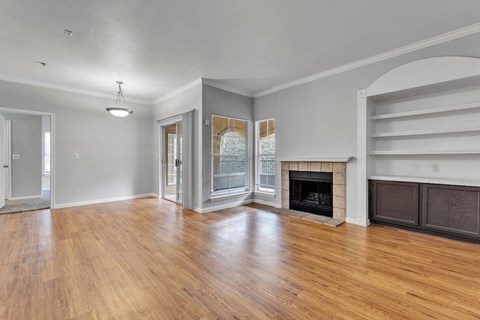 A living room with a fireplace and a sliding door.