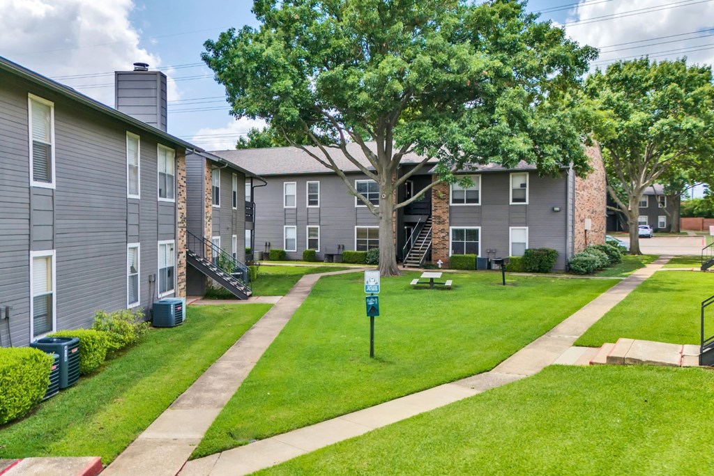 our apartments have a spacious courtyard with grass and trees