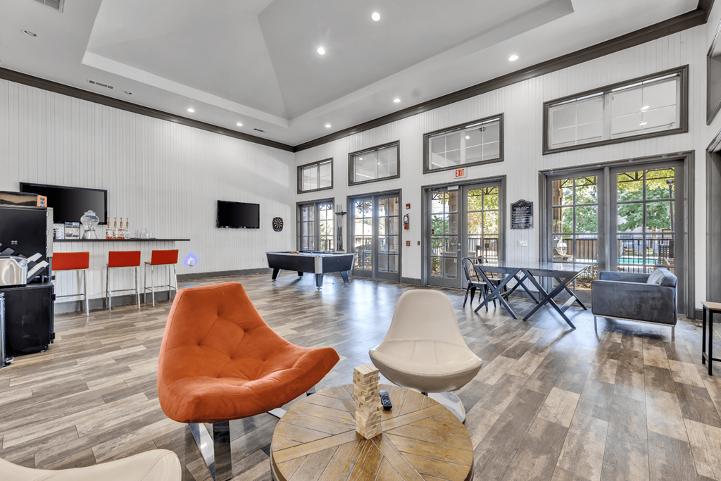 a living room with a couch and chairs and a table
