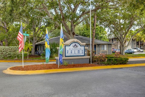 the building where the hotel is located has flags in front of it