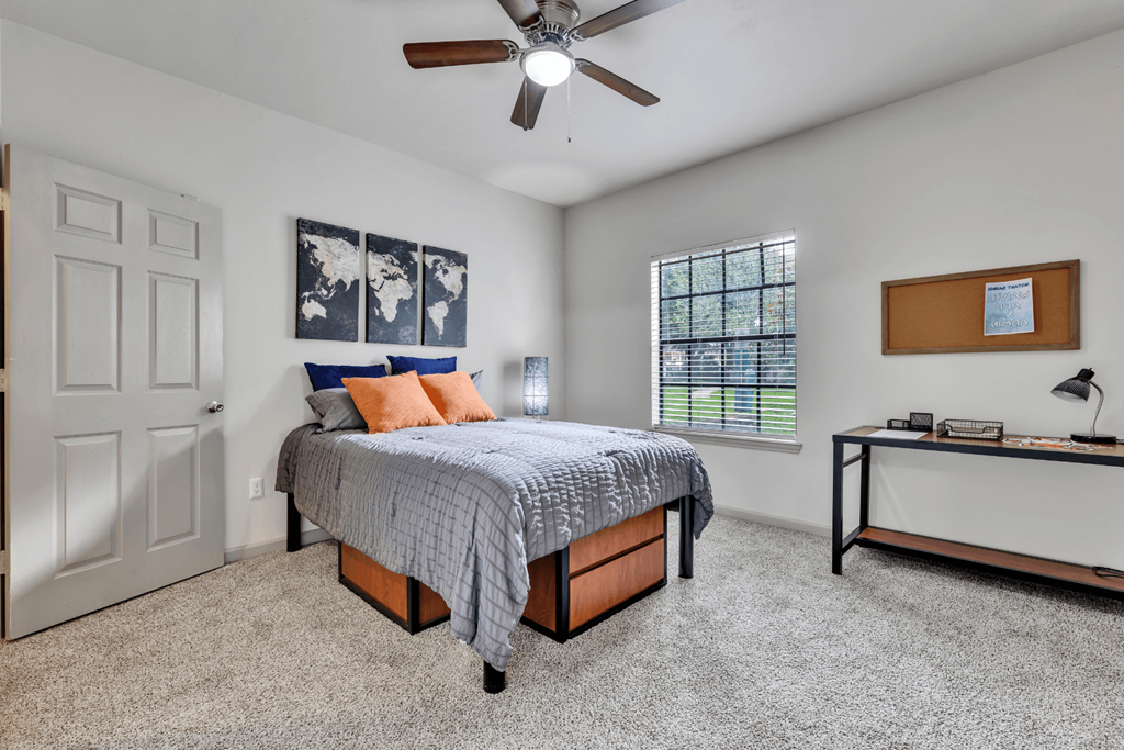 a bedroom with a bed and a ceiling fan