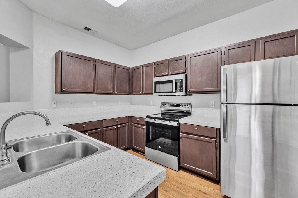 the kitchen of a home with wooden cabinets and stainless steel appliances