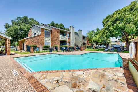 the pool is next to a house with a swimming pool