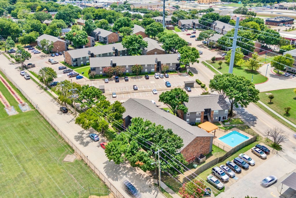 an aerial view of a neighborhood with houses and a parking lot