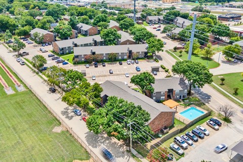 an aerial view of a neighborhood with houses and a parking lot