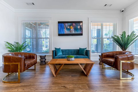 A living room with a brown leather chair and a wooden coffee table.