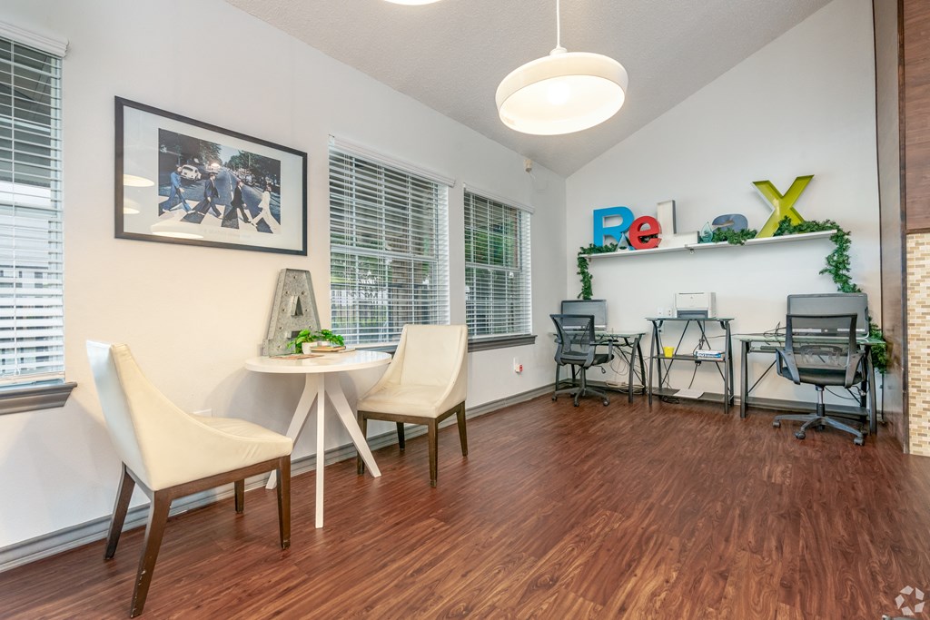 a living room with a table and chairs and a large window