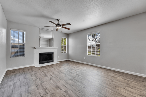 A spacious room with a fireplace at Arrowood Apartments, Houston, Texas