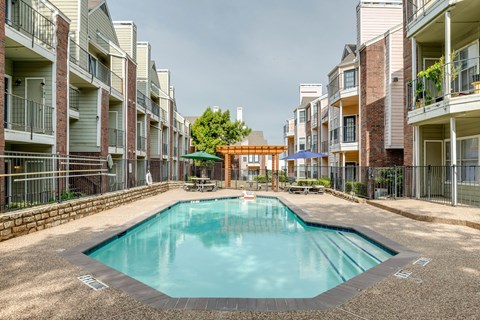A swimming pool in the middle of apartment buildings.