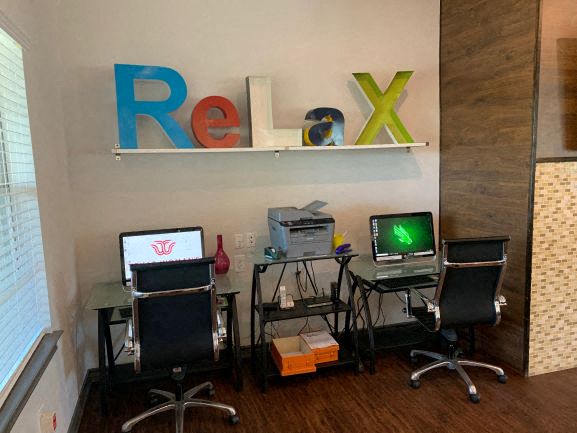 a room with two computers and a desk