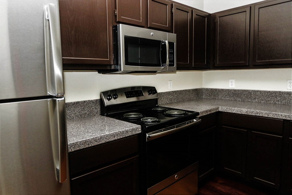 a kitchen with granite counter tops and stainless steel appliances