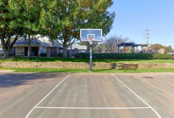 a basketball hoop in the middle of a parking lot