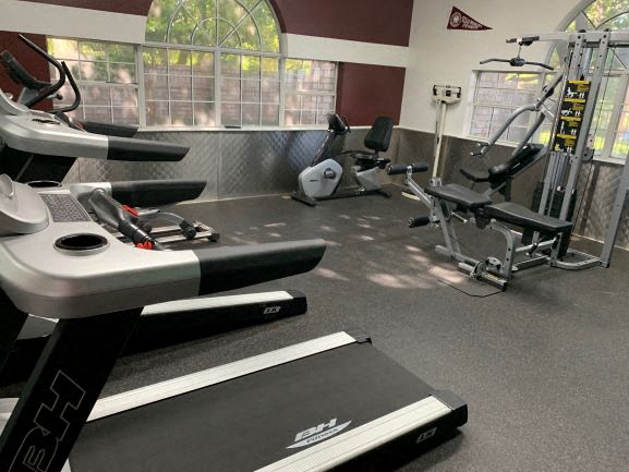 a gym with some weights and chairs in it