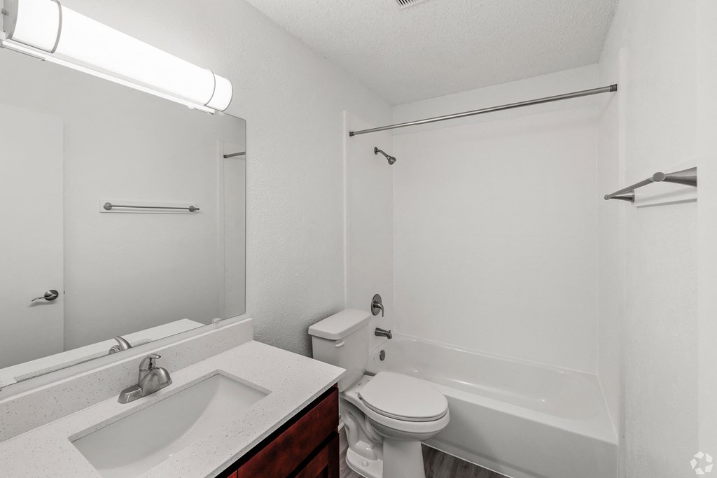 a bathroom with a sink toilet and a bath tub