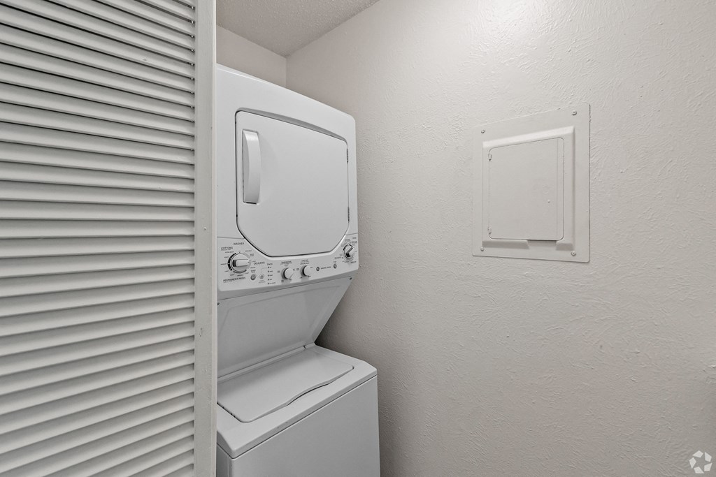 the laundry room has a washer and dryer and a window