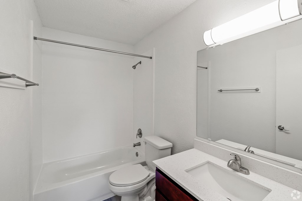 a bathroom with a sink toilet and a bath tub