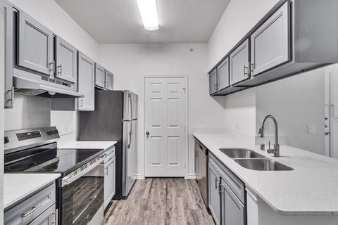 A kitchen with white cabinets and a black stove top oven.