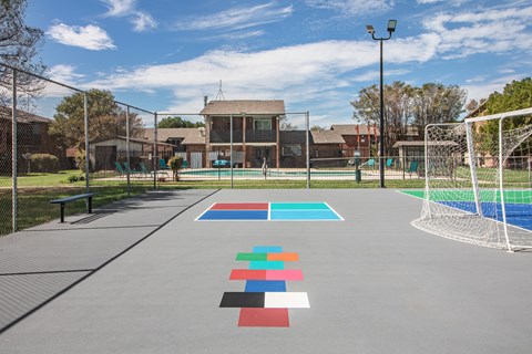 A soccer field with a goal and a bench.