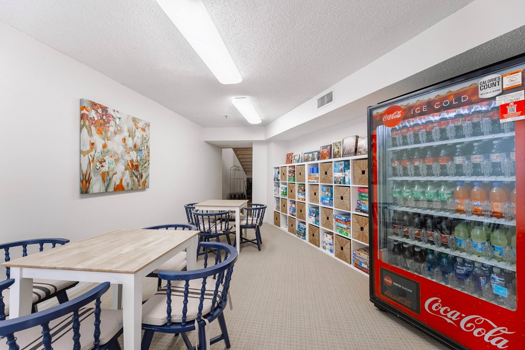a dining room with tables and chairs and a vending machine